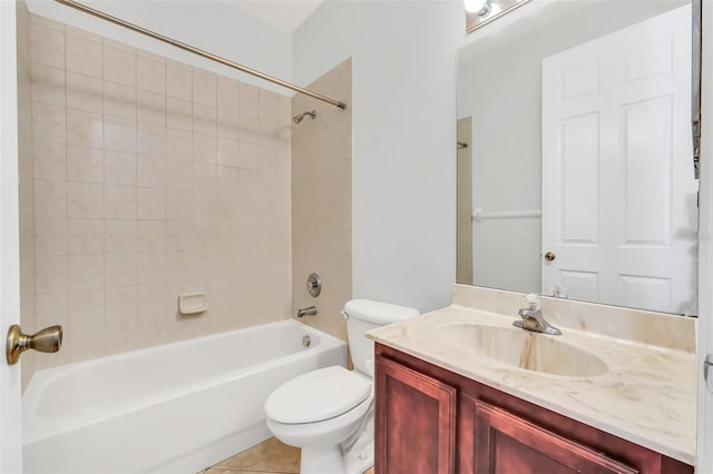 full bathroom featuring toilet, vanity, tile patterned floors, and tiled shower / bath combo