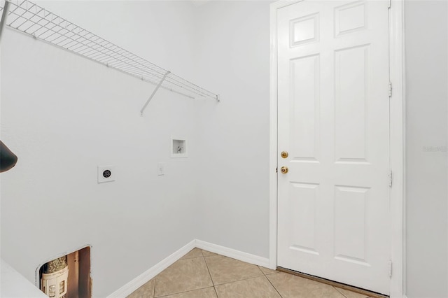 washroom with hookup for an electric dryer, light tile patterned floors, and washer hookup