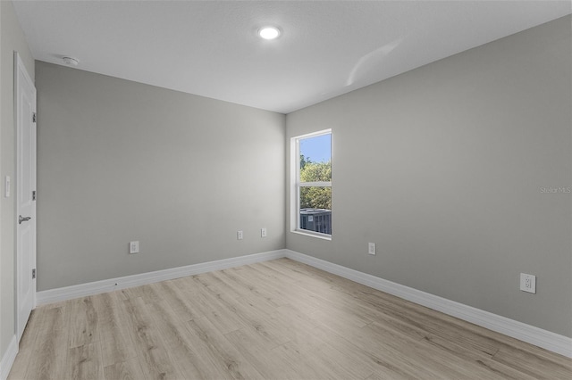 empty room with light hardwood / wood-style flooring