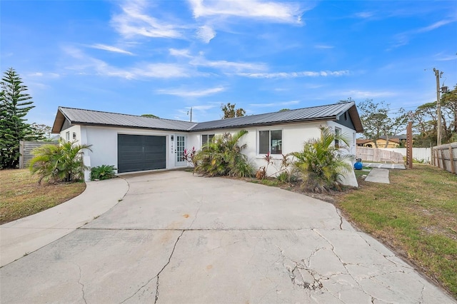 view of front facade featuring a front yard and a garage