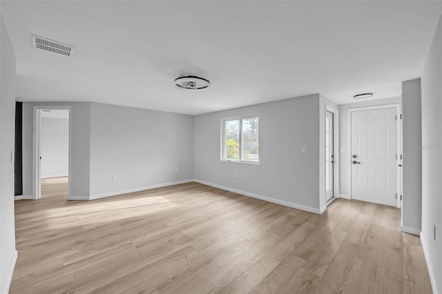 empty room with light hardwood / wood-style flooring