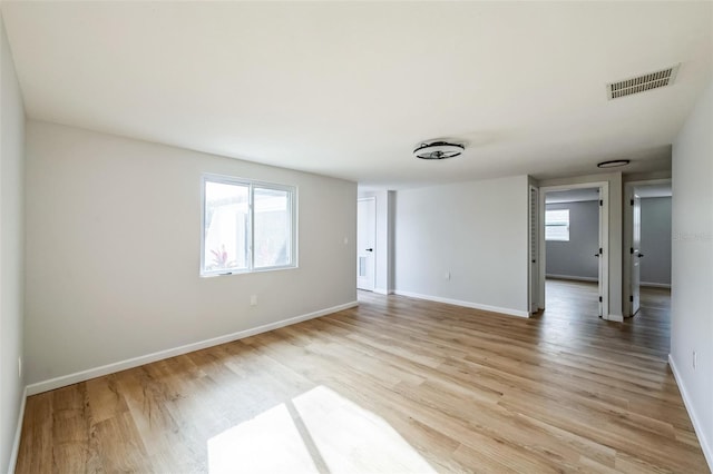 empty room with light hardwood / wood-style flooring