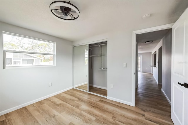 unfurnished bedroom featuring hardwood / wood-style floors and a closet