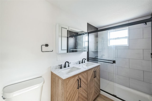 bathroom featuring toilet, vanity, and walk in shower