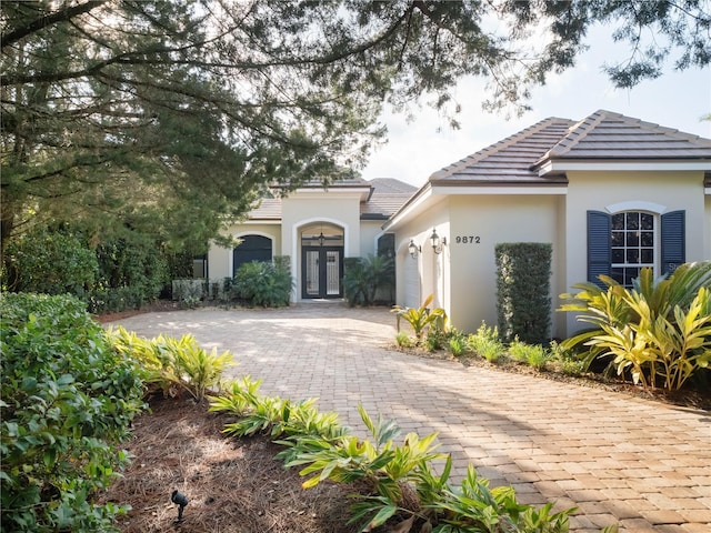 view of front of property with french doors and a garage