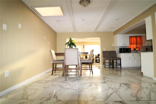 dining space with wooden walls