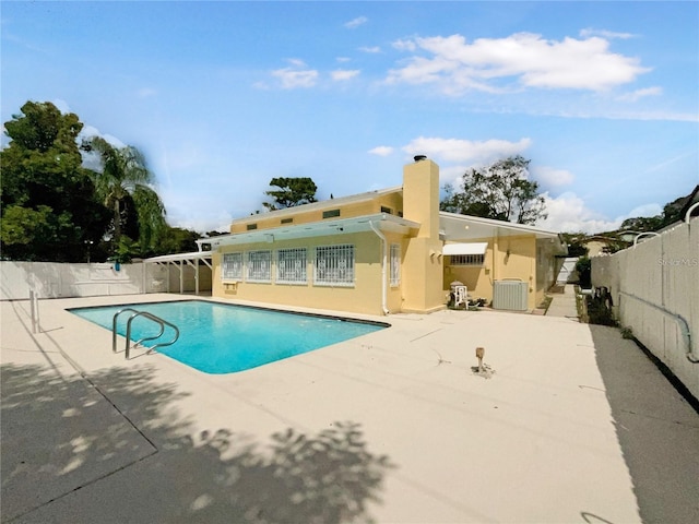 view of pool featuring central air condition unit and a patio