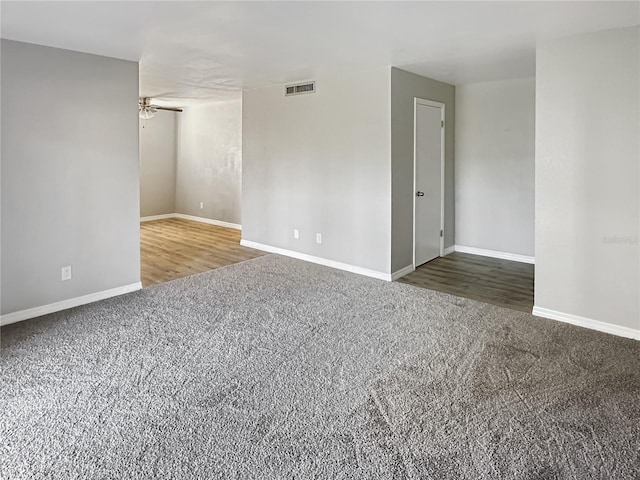 carpeted spare room featuring ceiling fan