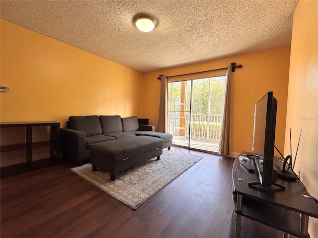 living room with dark wood-type flooring and a textured ceiling