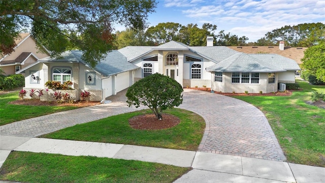 view of front of house featuring a front yard and a garage