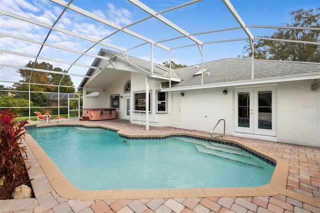 view of swimming pool featuring glass enclosure, french doors, a patio, and a hot tub