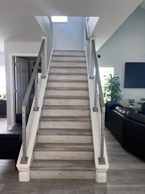 stairs featuring hardwood / wood-style flooring