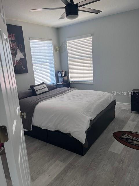 bedroom featuring hardwood / wood-style flooring and ceiling fan