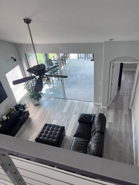 living room featuring hardwood / wood-style floors and ceiling fan