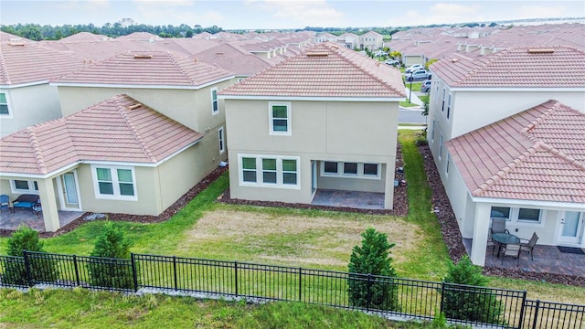 rear view of property featuring a patio area and a yard