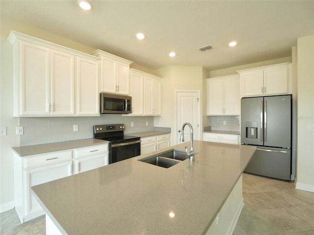 kitchen with white cabinetry, sink, a center island with sink, and appliances with stainless steel finishes