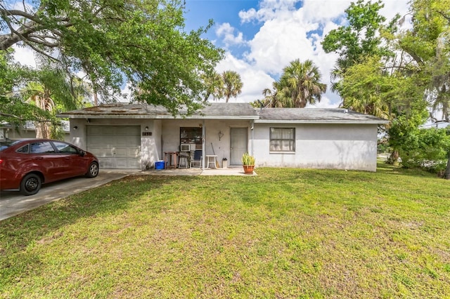 single story home with a garage and a front lawn