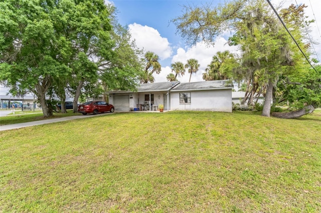 ranch-style house featuring a garage and a front lawn