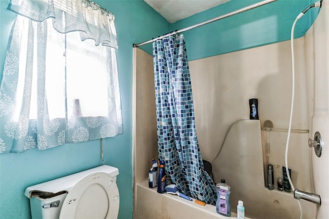 bathroom with shower / bath combo and toilet