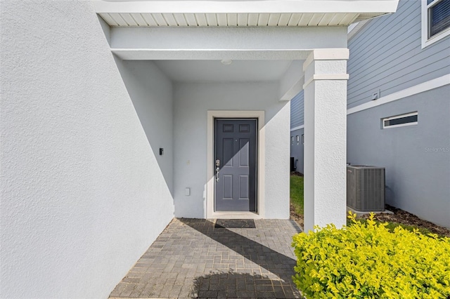 entrance to property featuring cooling unit