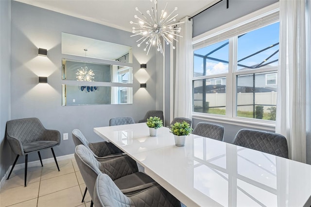 tiled dining room with a chandelier