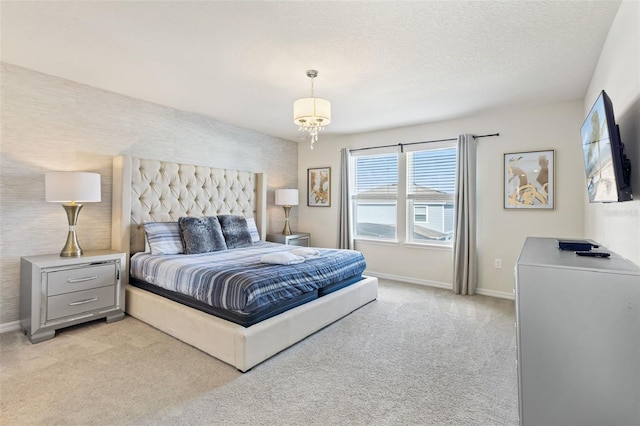 bedroom featuring light colored carpet and a textured ceiling