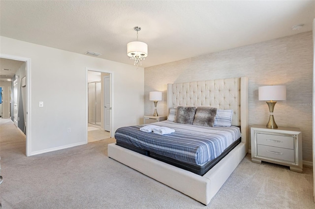 bedroom featuring light colored carpet and ensuite bathroom