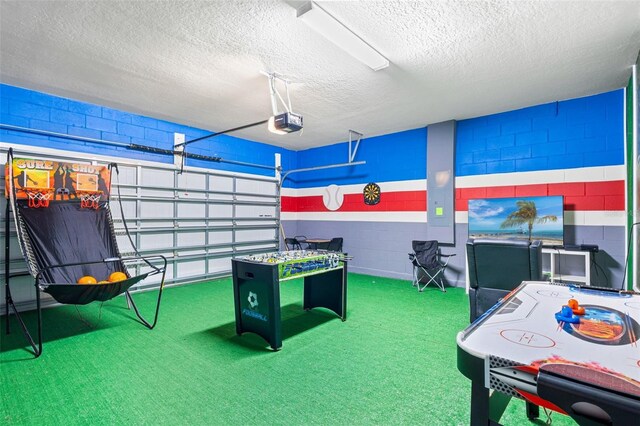 rec room featuring carpet flooring, a textured ceiling, and electric panel