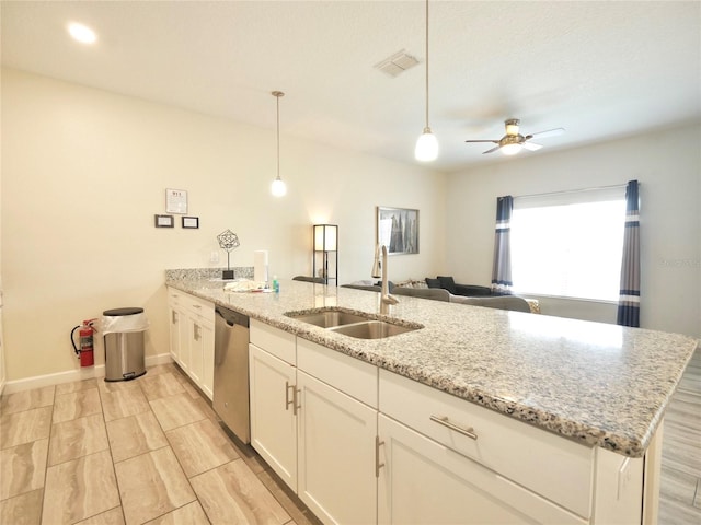 kitchen with stainless steel dishwasher, ceiling fan, sink, white cabinets, and hanging light fixtures