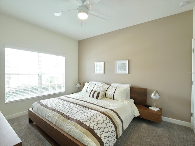 bedroom with ceiling fan and dark carpet