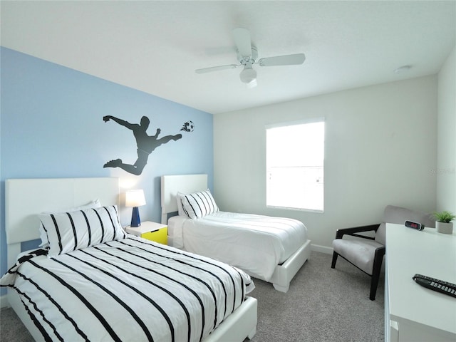 bedroom with ceiling fan and light carpet