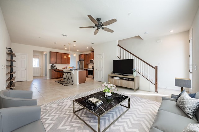 tiled living room with ceiling fan