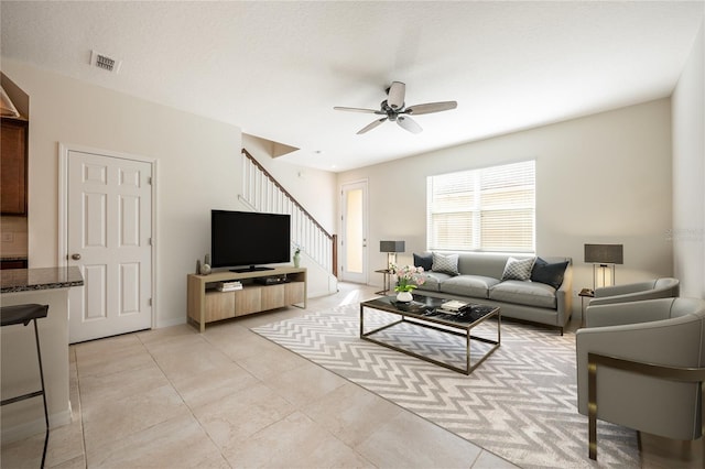 tiled living room with ceiling fan