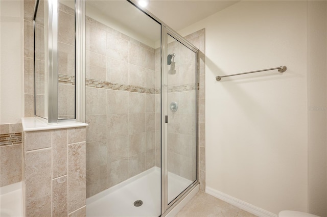 bathroom featuring tile patterned flooring and an enclosed shower