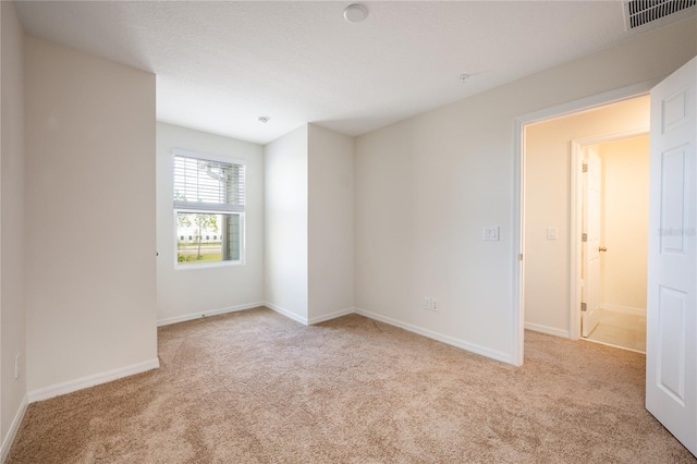 unfurnished room featuring light colored carpet