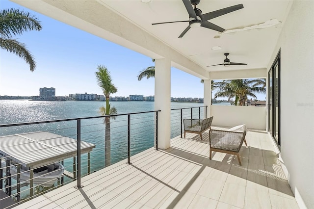 dock area with a water view and a balcony