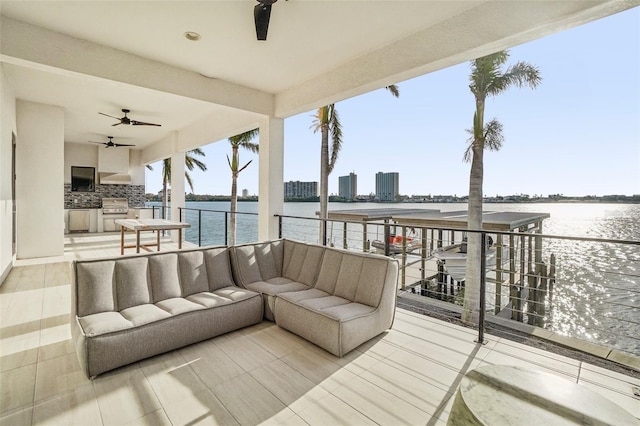 deck featuring a water view and exterior kitchen