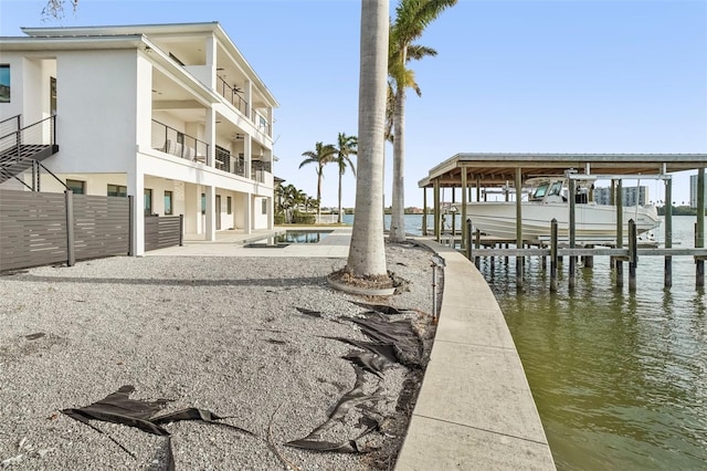 view of community with a water view and a dock