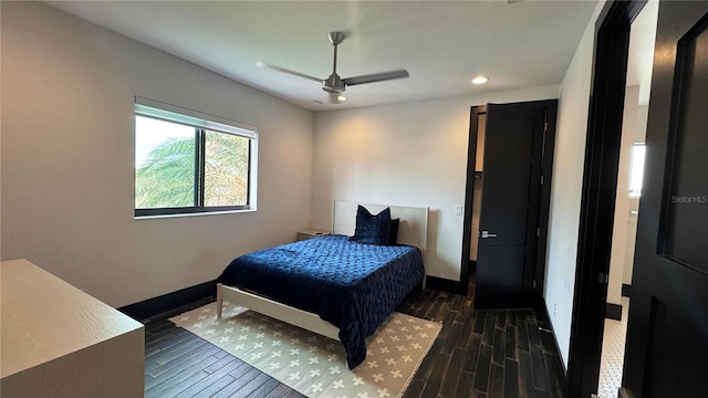 bedroom featuring ceiling fan and dark wood-type flooring