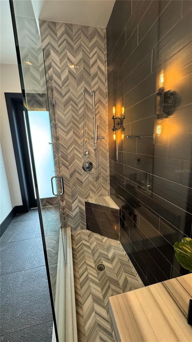 bathroom with a shower with door