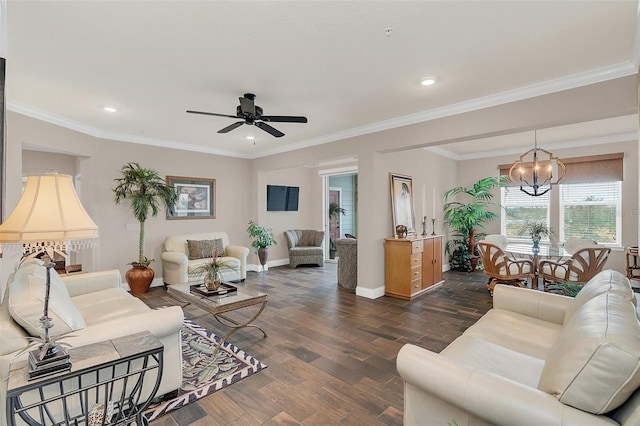 living room featuring dark hardwood / wood-style flooring, ceiling fan with notable chandelier, and ornamental molding