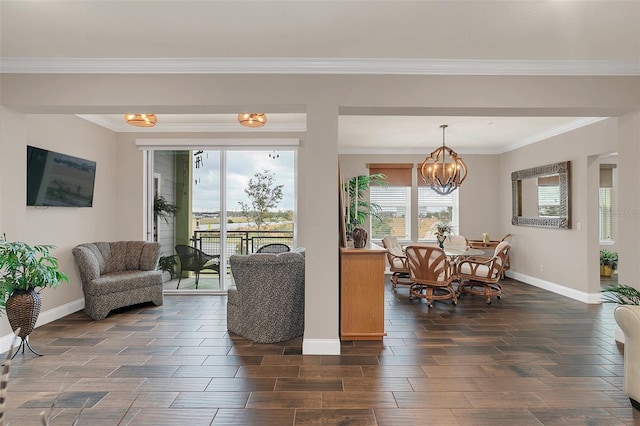 living room featuring a notable chandelier and crown molding