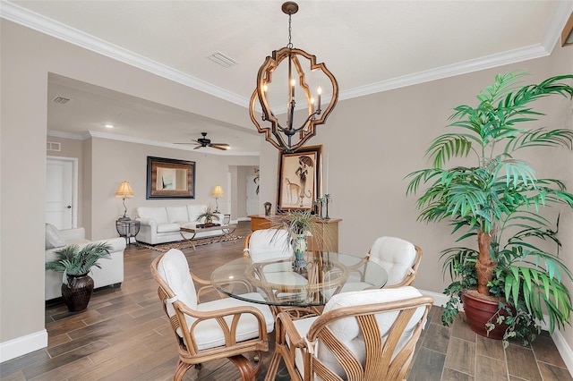 dining space featuring ceiling fan with notable chandelier and ornamental molding