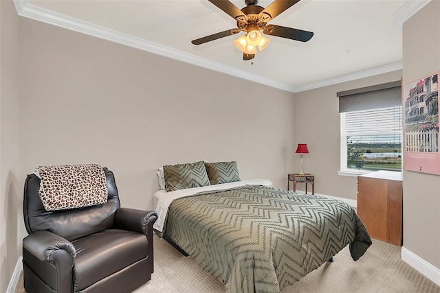 carpeted bedroom with ceiling fan and ornamental molding