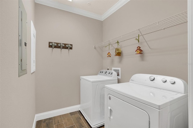 clothes washing area with separate washer and dryer, crown molding, and electric panel