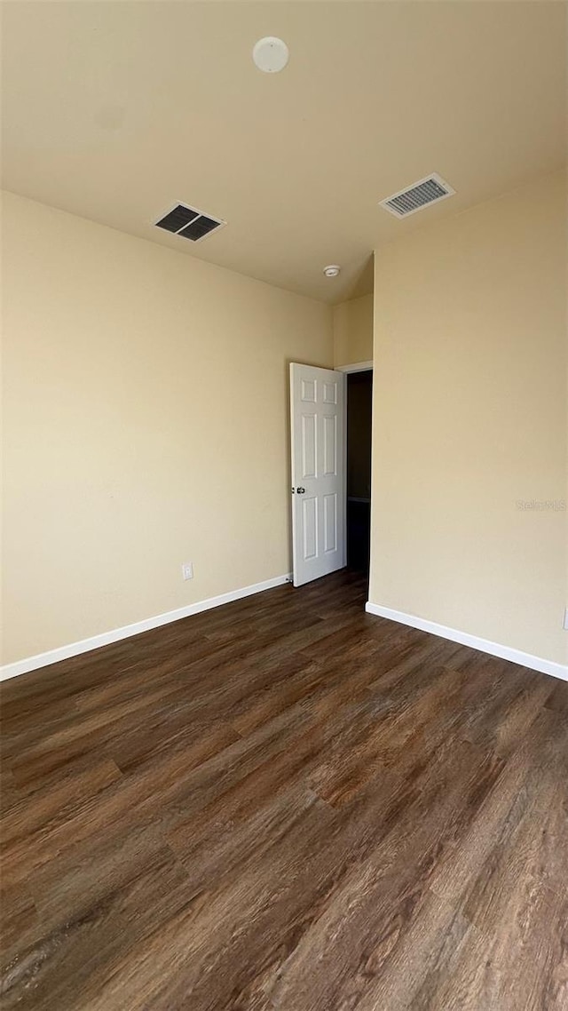 empty room featuring dark hardwood / wood-style flooring