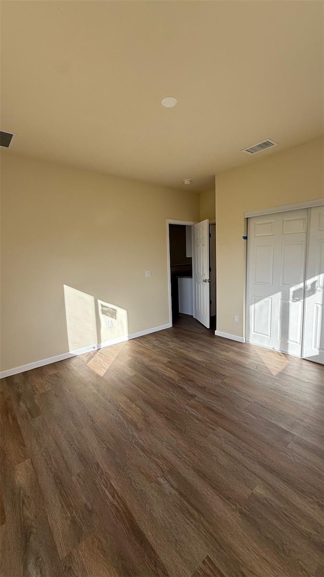 unfurnished bedroom featuring dark hardwood / wood-style floors