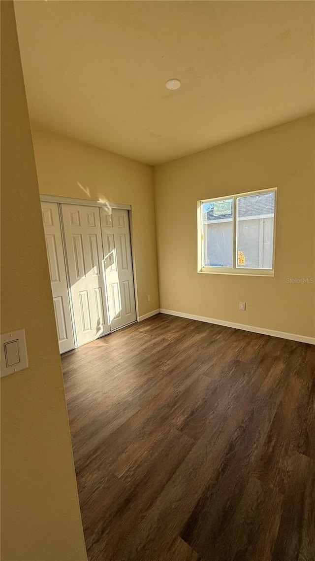 empty room featuring dark wood-type flooring