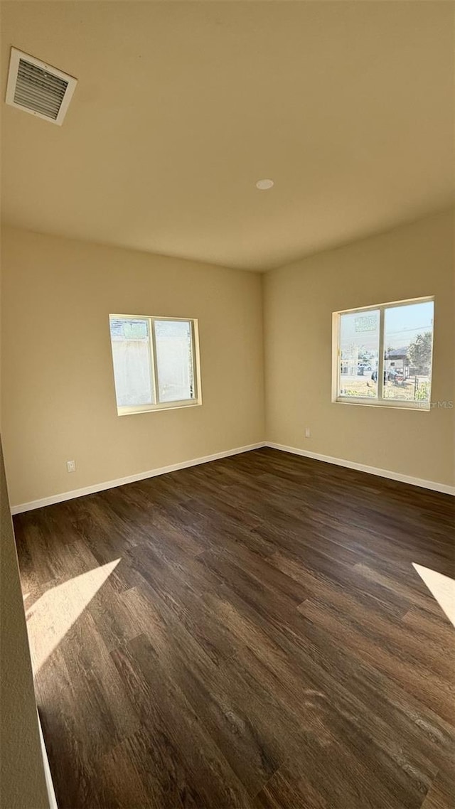 unfurnished room featuring dark hardwood / wood-style flooring