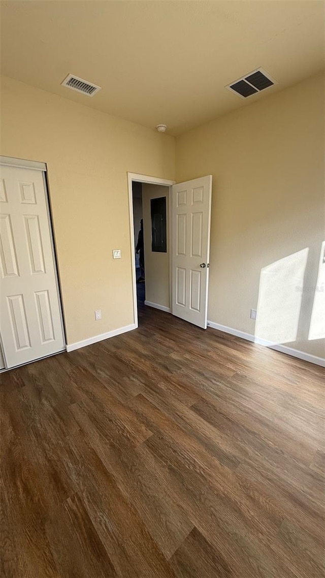 spare room with dark wood-type flooring